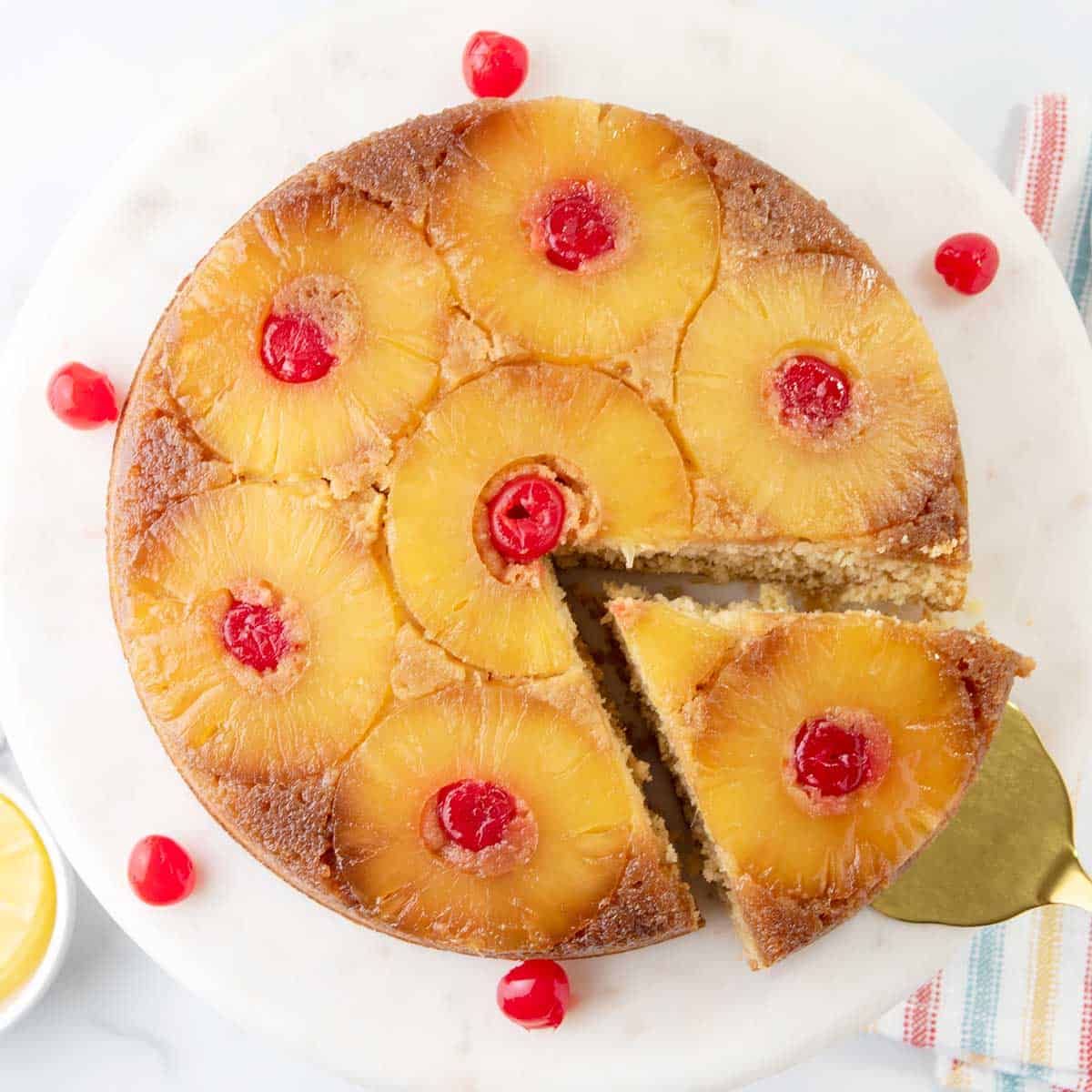 Overhead of finished pineapple upside down cake with a slice cut out.