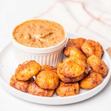 Air fried Pizza Bites on platter with dip.