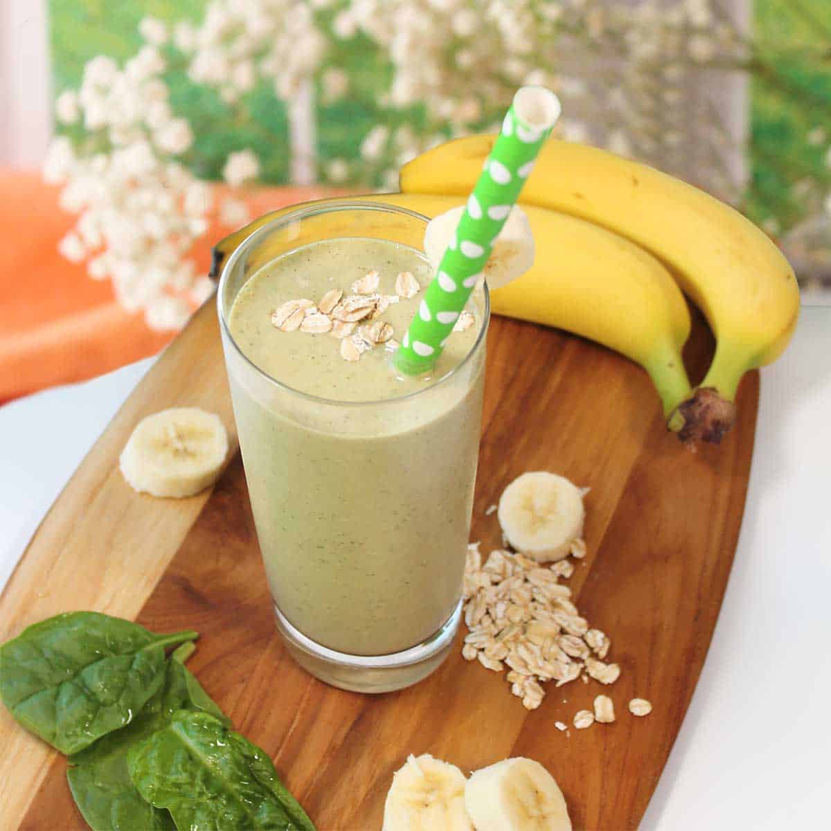 Banana oatmeal smoothie with straw.