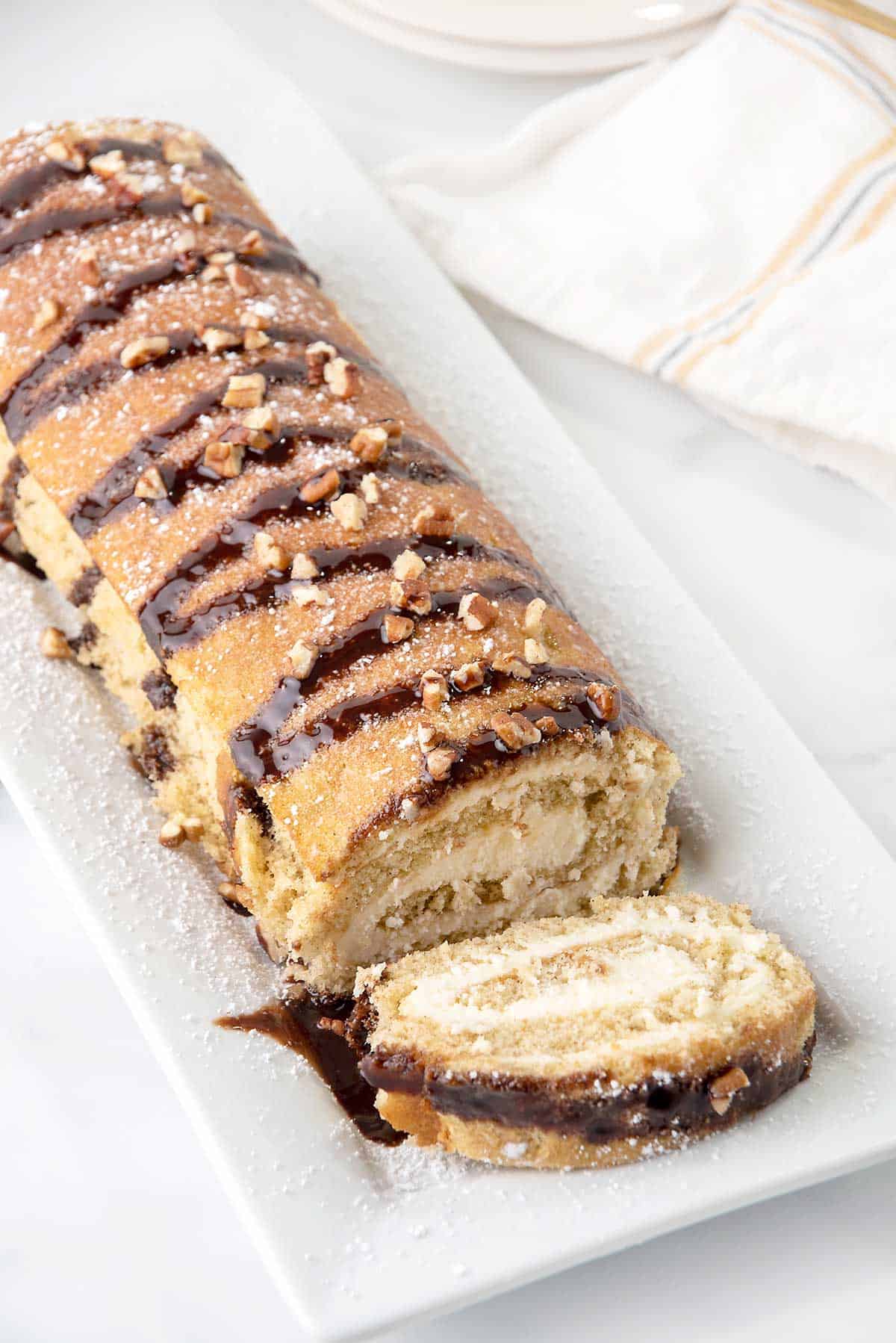 Banana Roll with one slice on platter.
