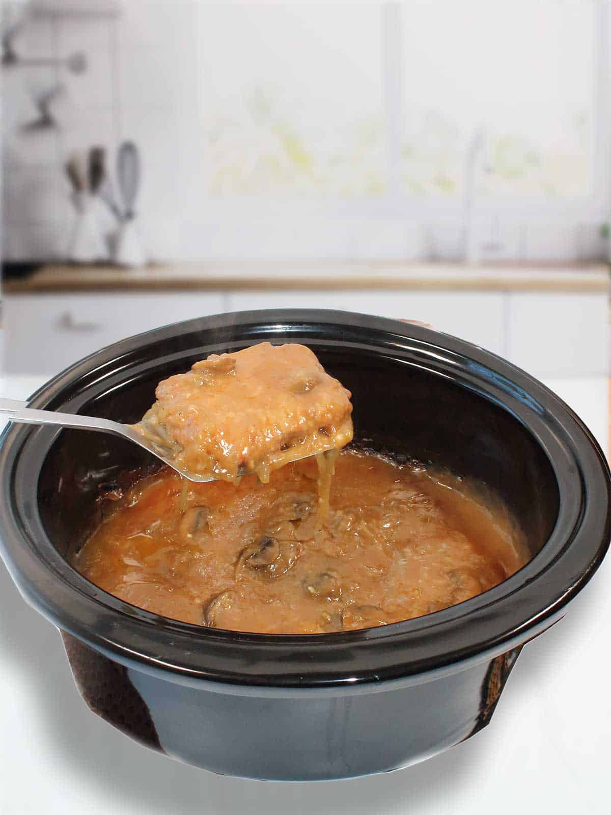 Lifting cube steak from crock pot.