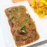 Platter of cube steak and gravy on counter.