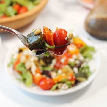 Bite of salad on fork.