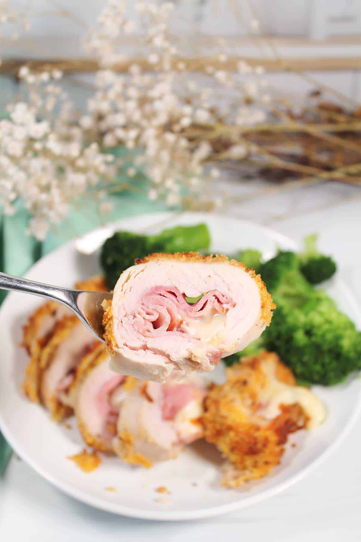 Bite of air fried chicken cordon bleu on fork.