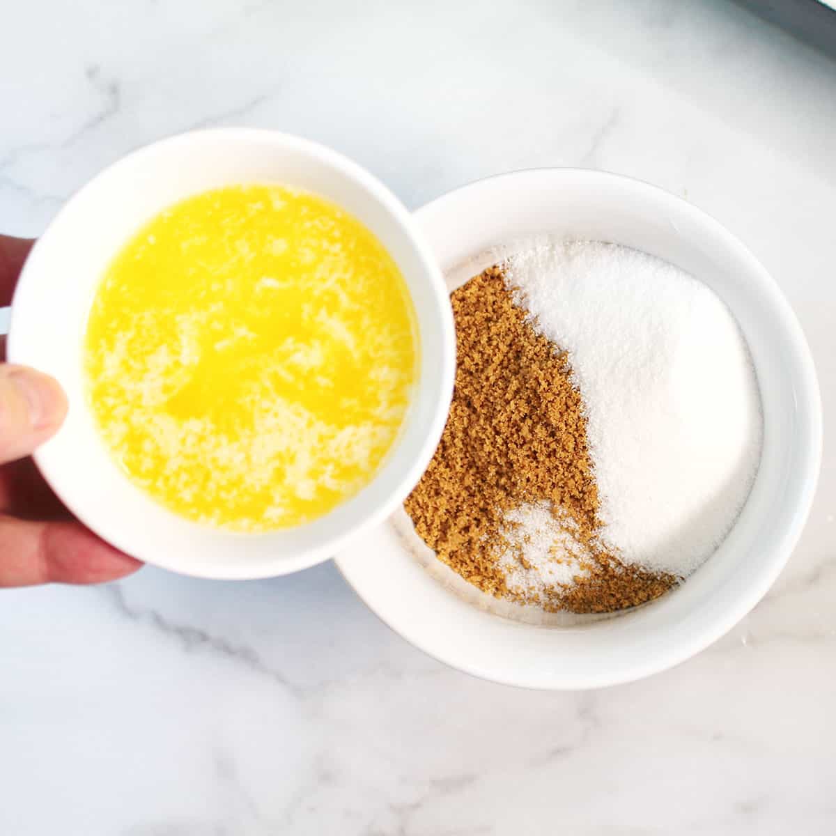 Adding melted butter to graham cracker sugar mixture.