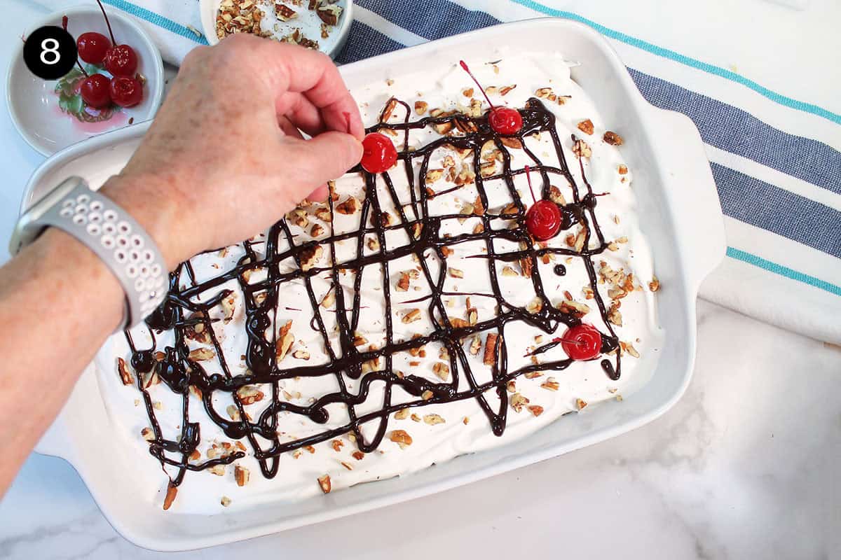 Adding cherries to top of dessert.