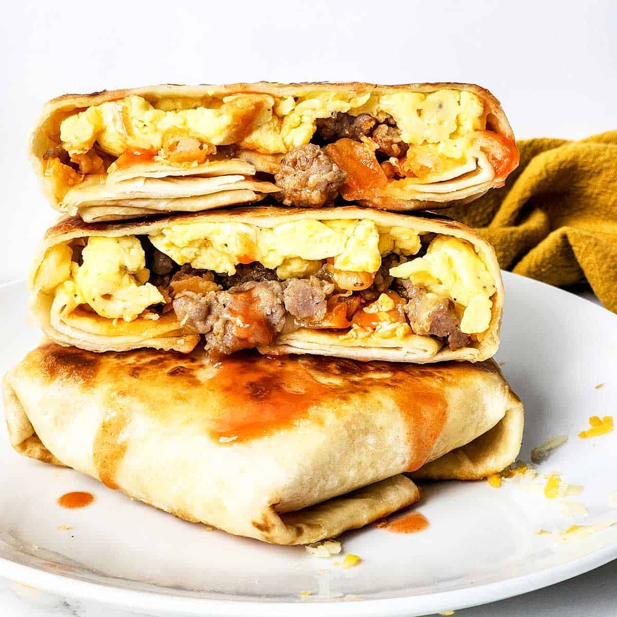 Breakfast crunchwrap stacked on plate.