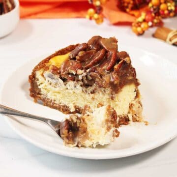 Slice of cheesecake with bite on fork.