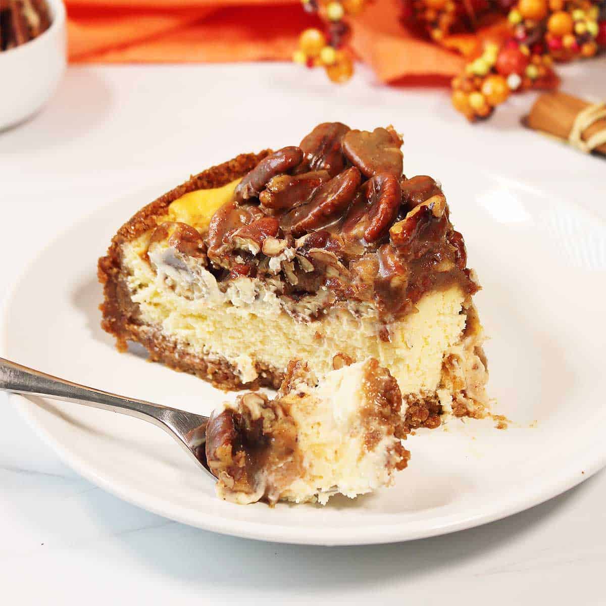 Slice of cheesecake with bite on fork.