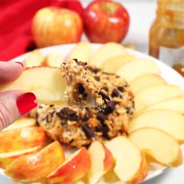 Scooping up some caramel cream cheese on apple slice.