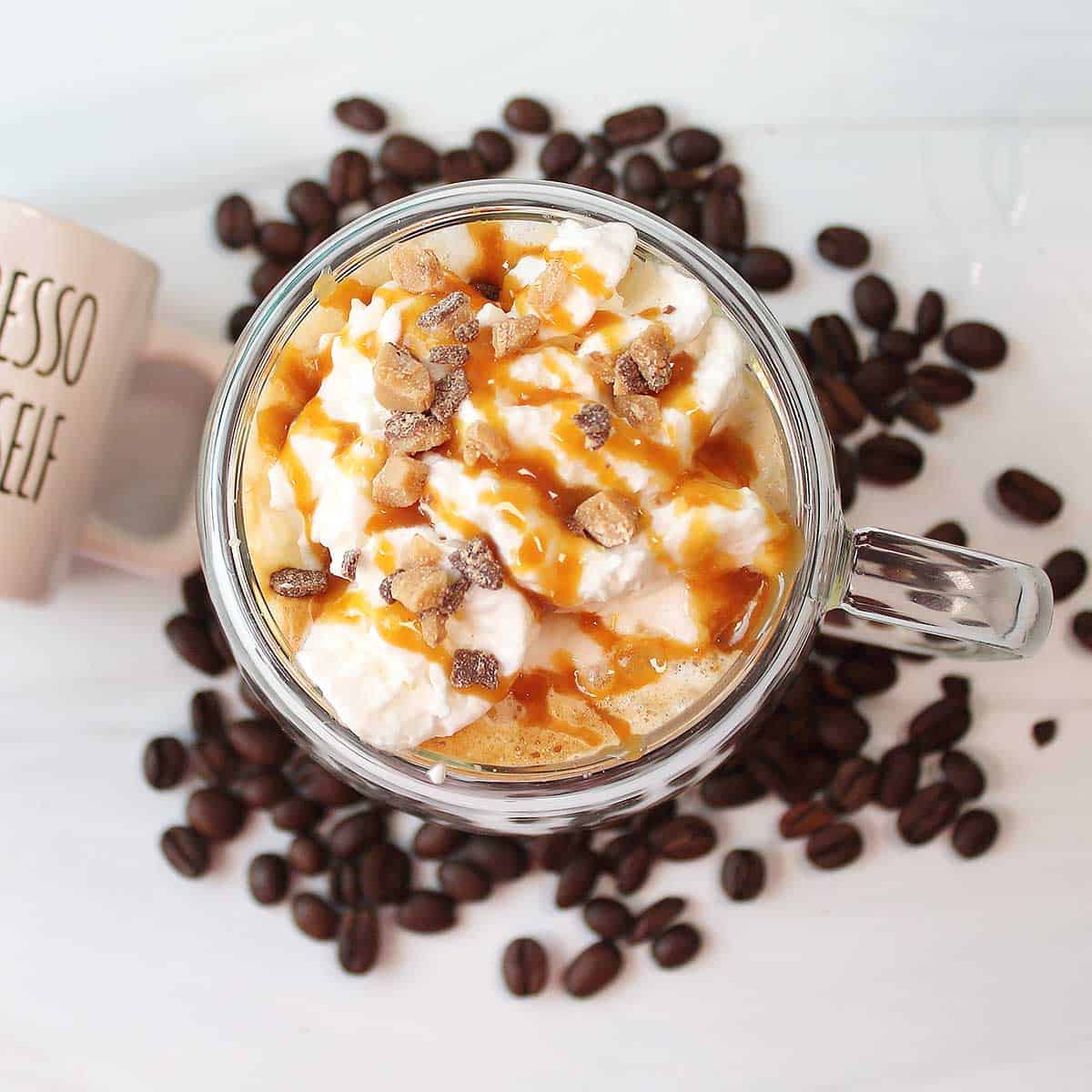Overhead of caramel brulee latte with toppings.