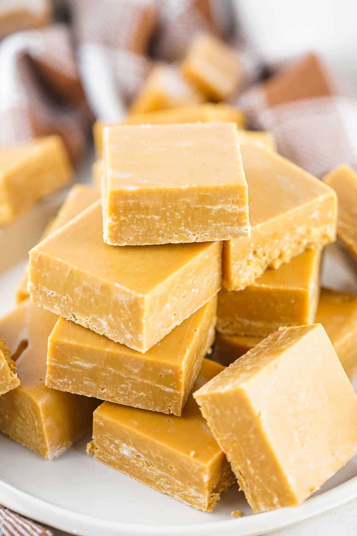 Stack of caramel fudge on plate.