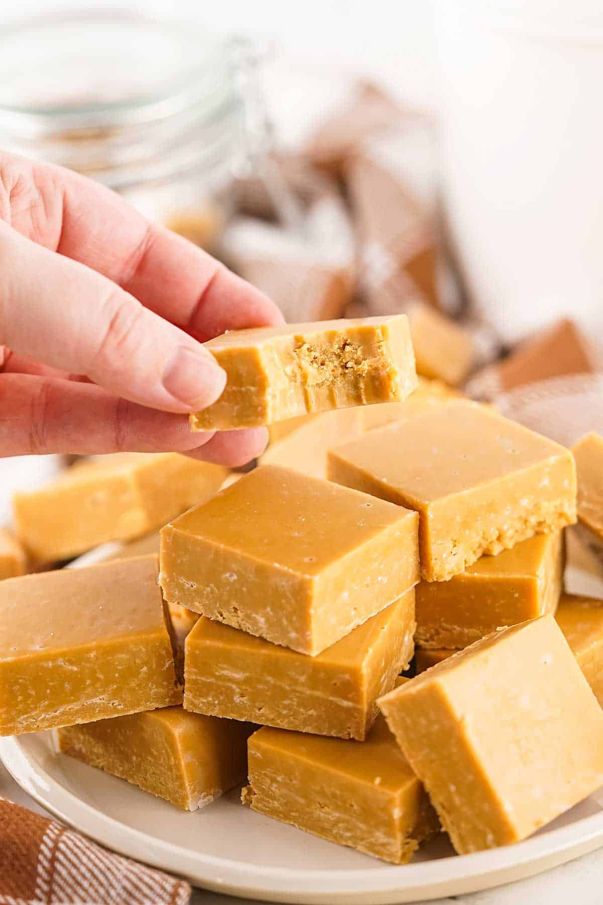 Holding piece of fudge with bite out of it.