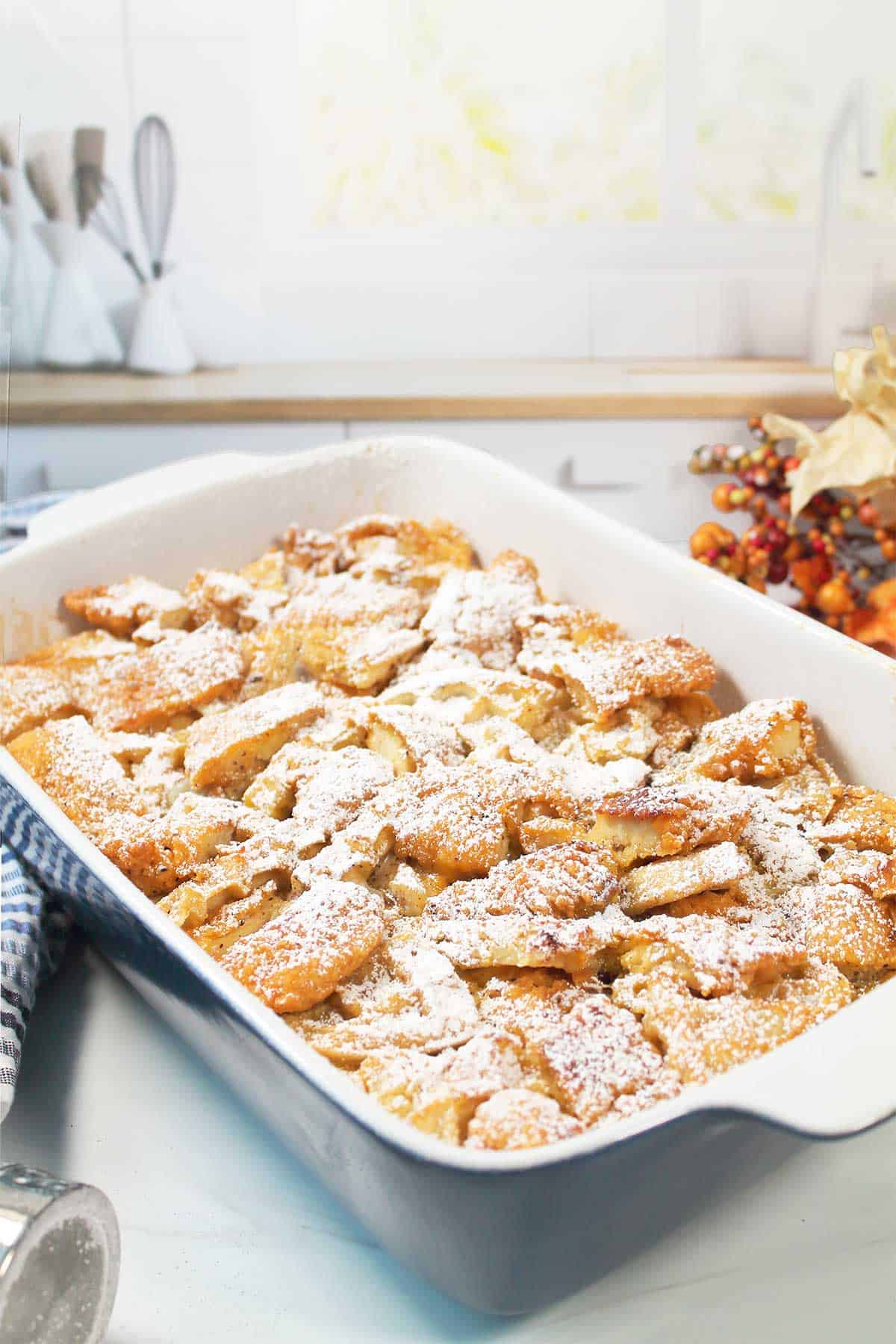 Powdered sugar coated baked chicken and waffles casserole.