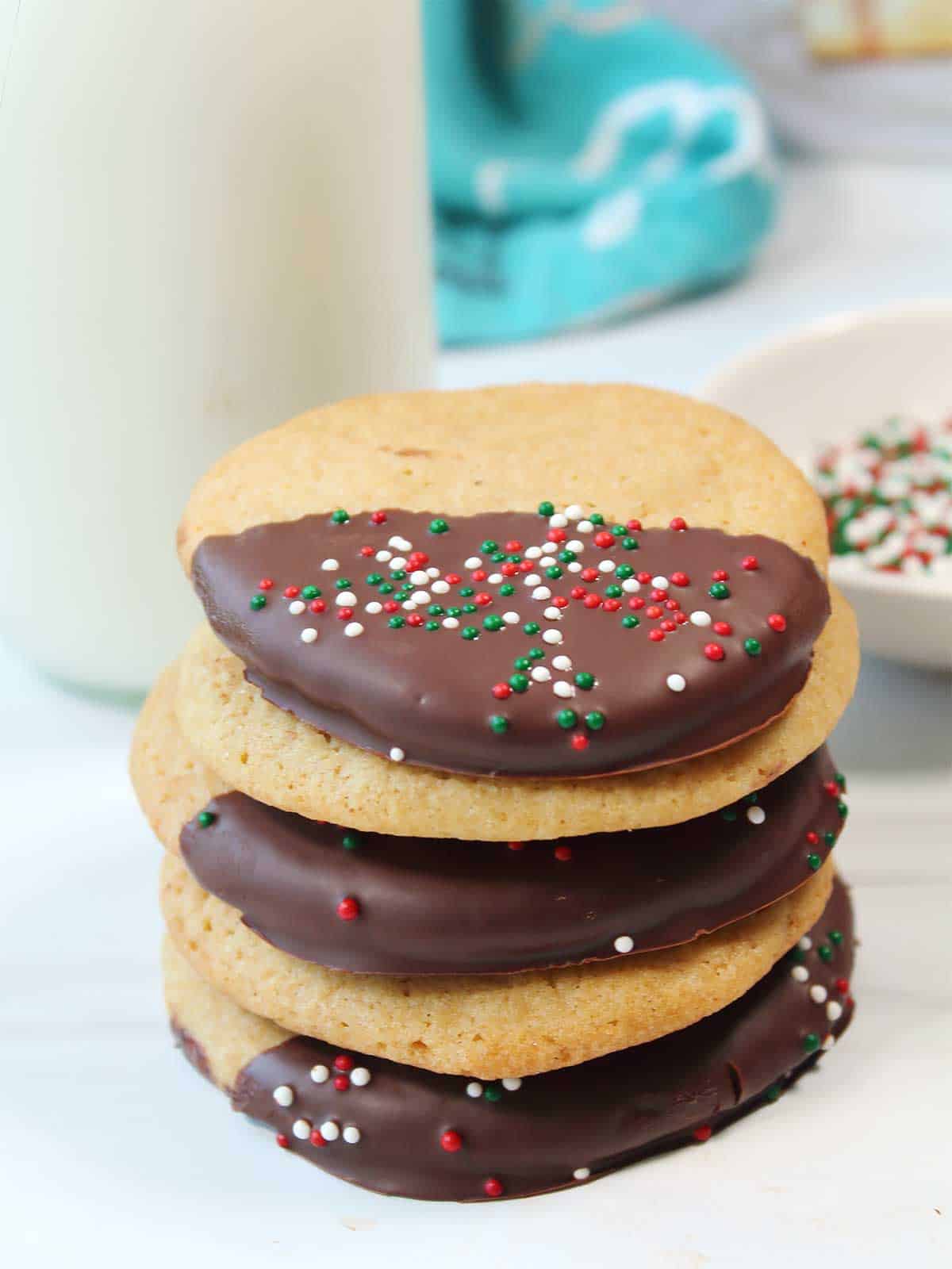 Stacked coffee cookies with milk.