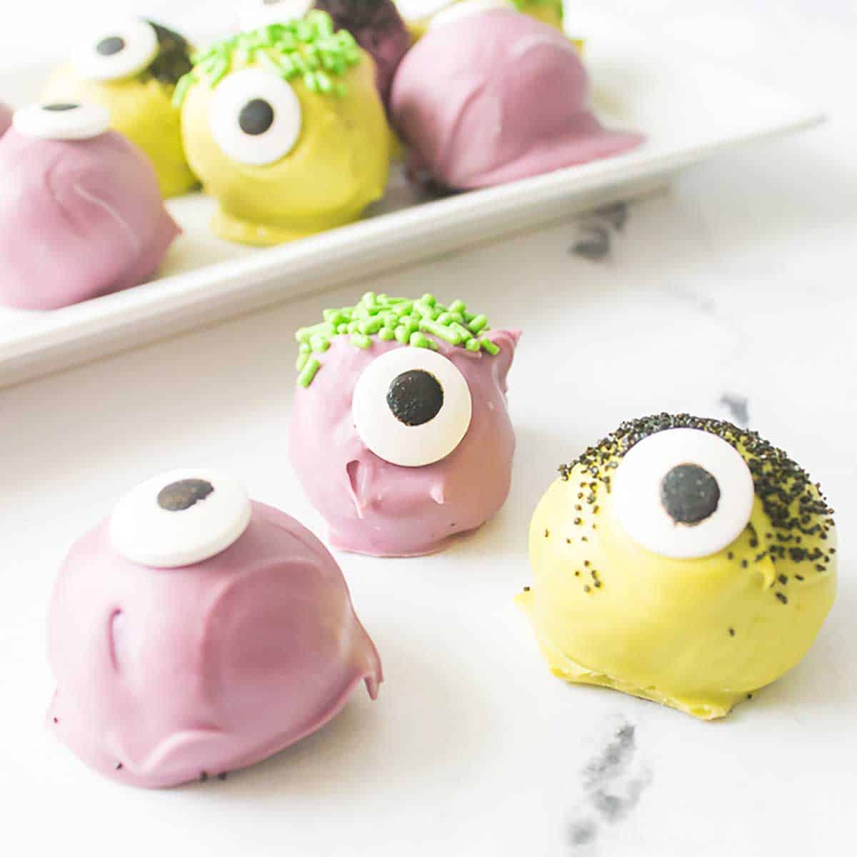 Three monster Oreo truffles in front of platter.