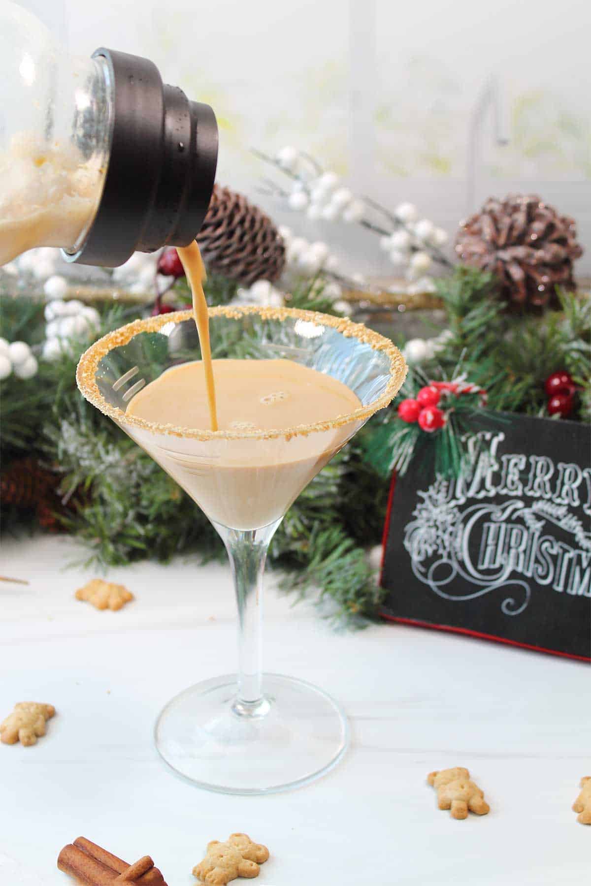 Straining martini into prepared glass.