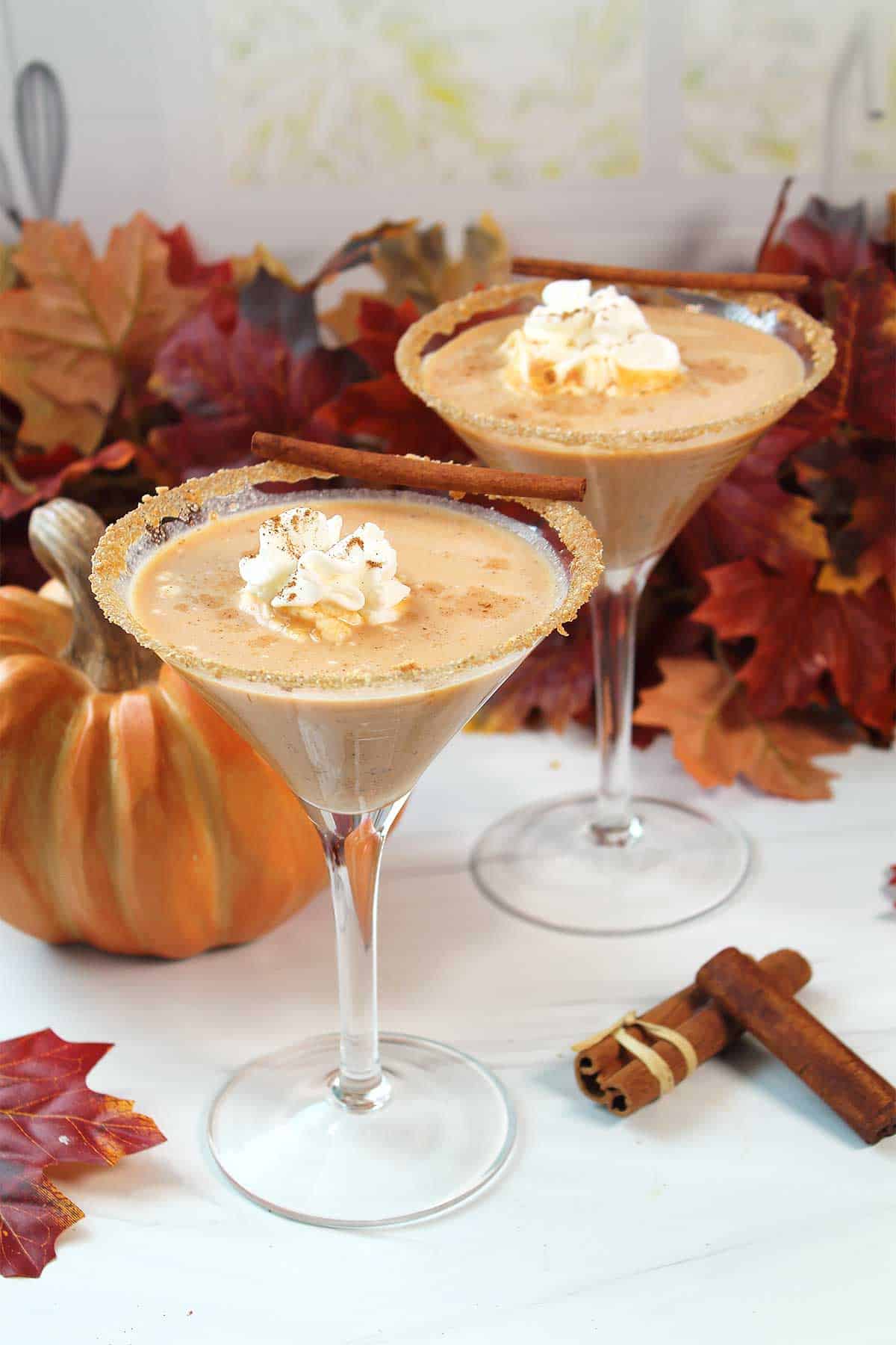 Two pumpkin spice martinis with fall leaves.