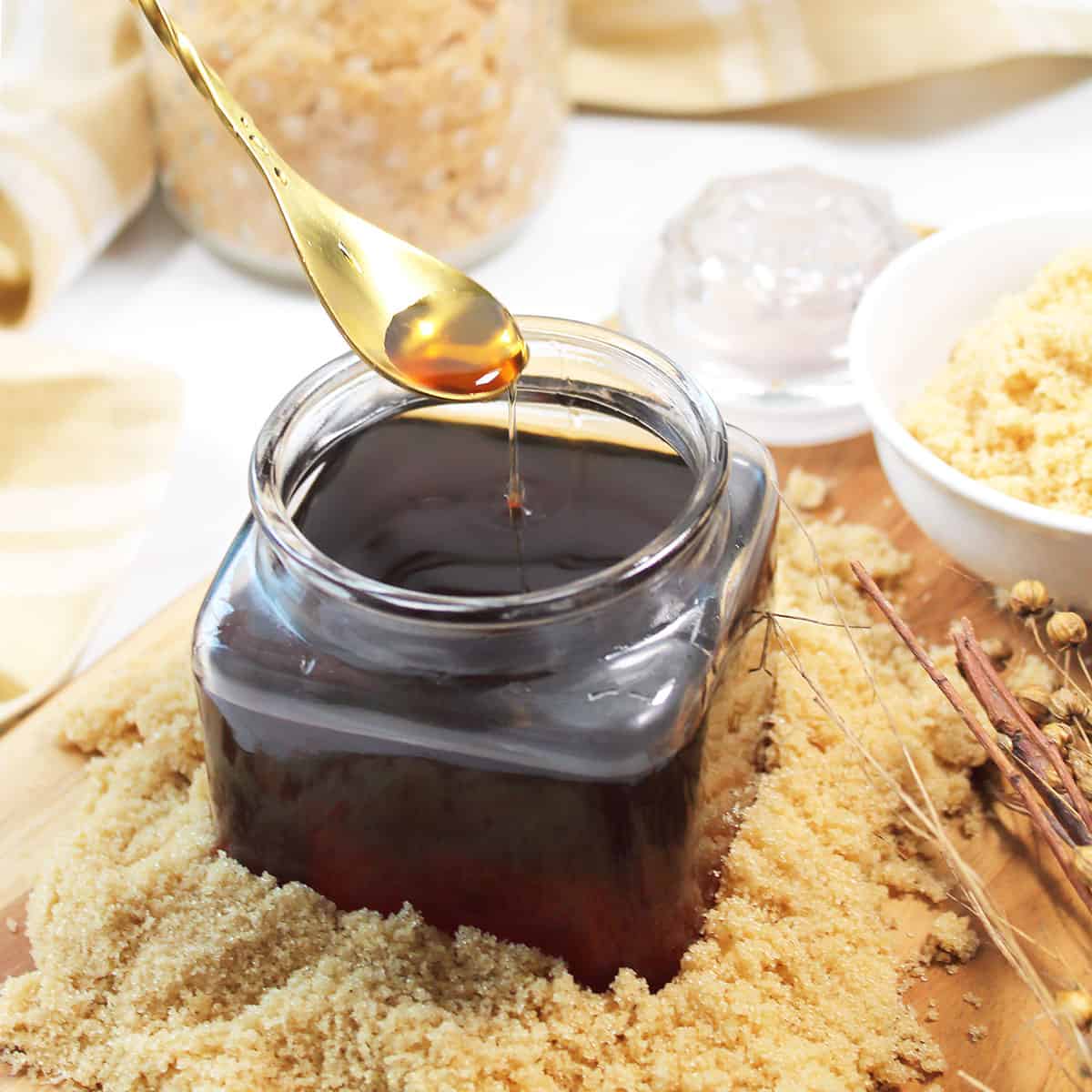 Spooning brown sugar simple syrup out of jar.