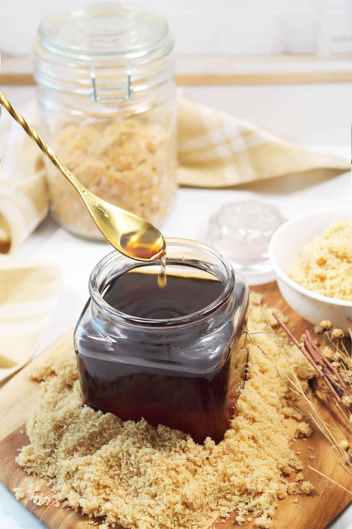 Brown sugar simple syrup dripping off of spoon.