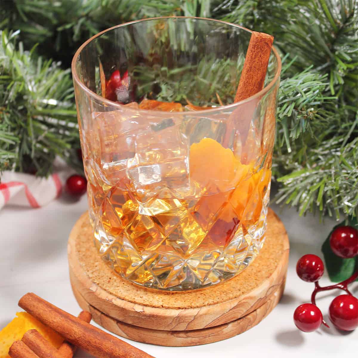 Closeup of bourbon cocktail with cinnamon stick.