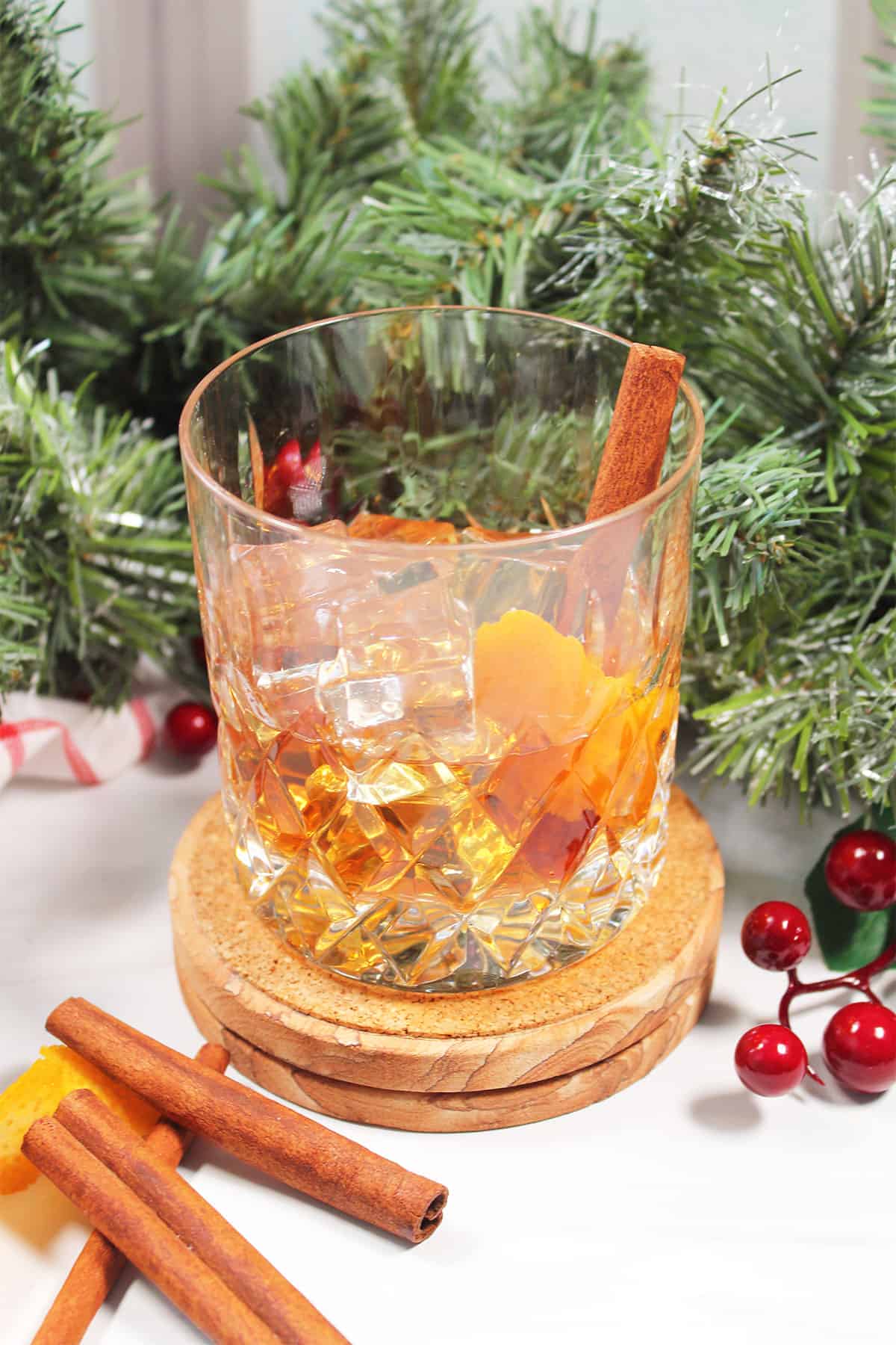 Brown sugar old fashioned over ice with cinnamon stick and orange peel.