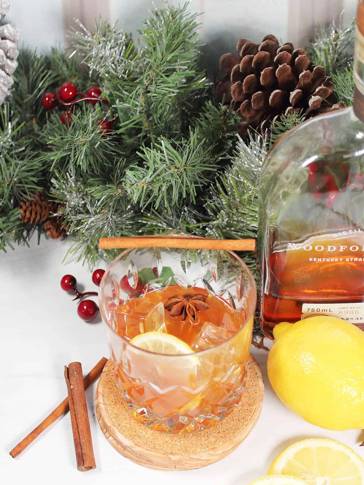 Cinnamon Maple Whiskey Sour with lemon slice and cinnamon stick garnish.