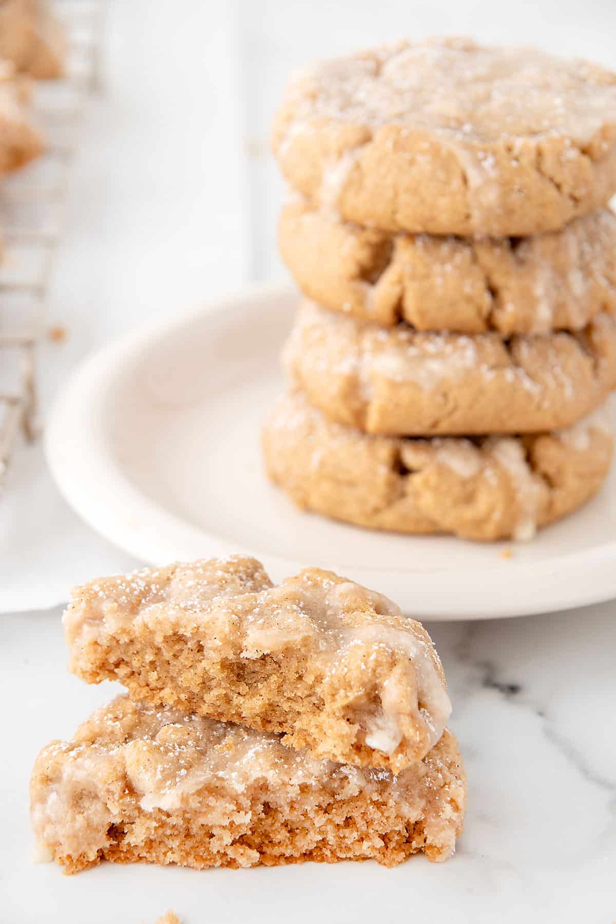 Halved cookie showing inside with stacked cookies in back.