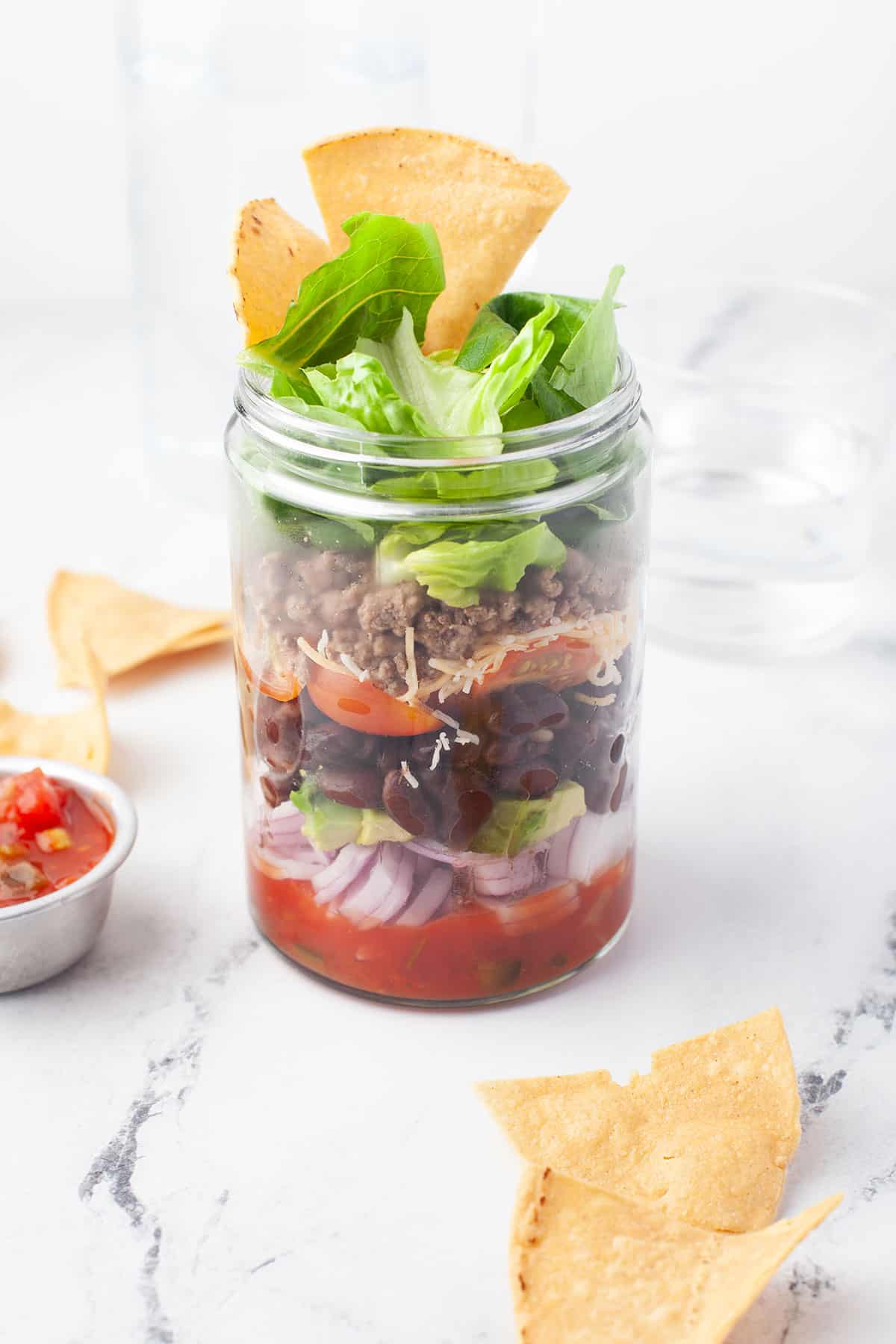 Taco Salad in a Jar topped with tortilla chips.