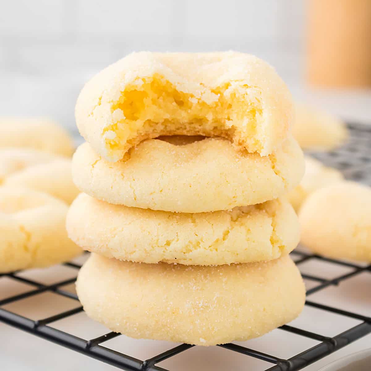 Stack of cookies with bite out of top one.