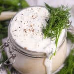 Closeup of homemade herb ranch dressing in jar.