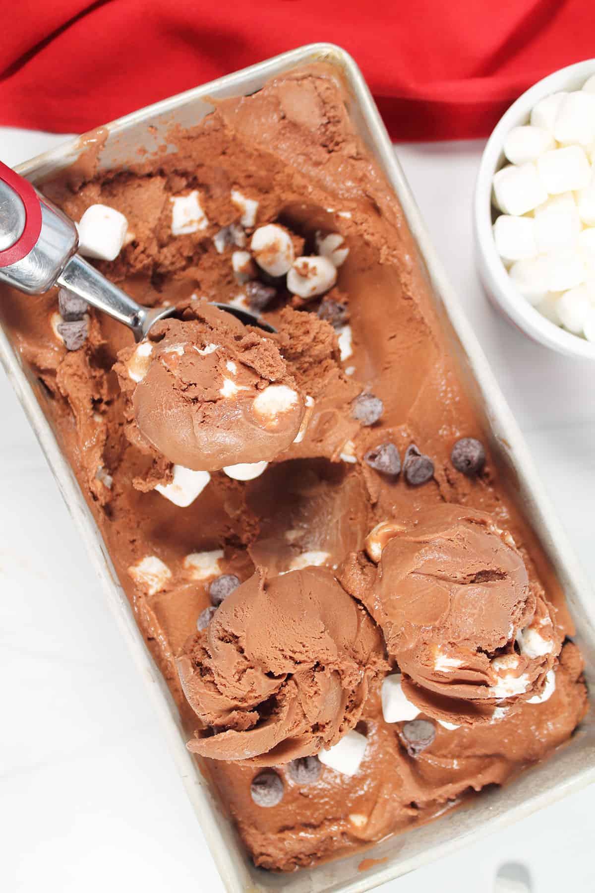Hot Cocoa Ice Cream with ice cream scoop and three scoops.
