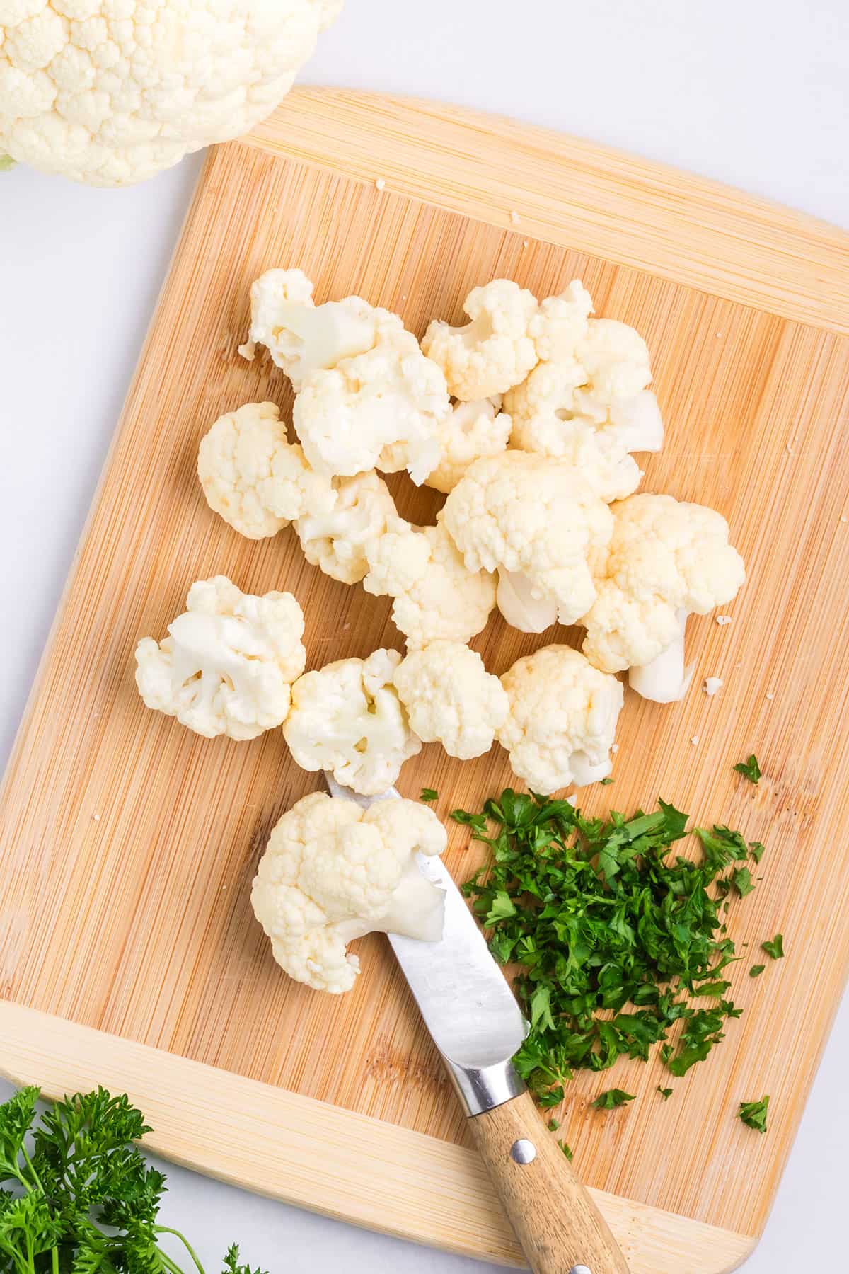 Cutting cauliflower into pieces.