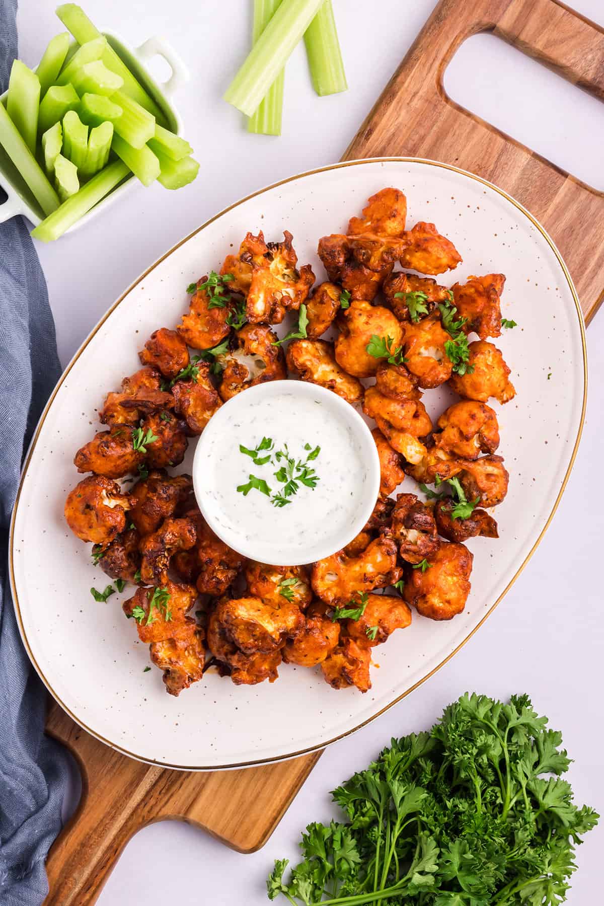 Platter of buffalo cauliflower with creamy dip.
