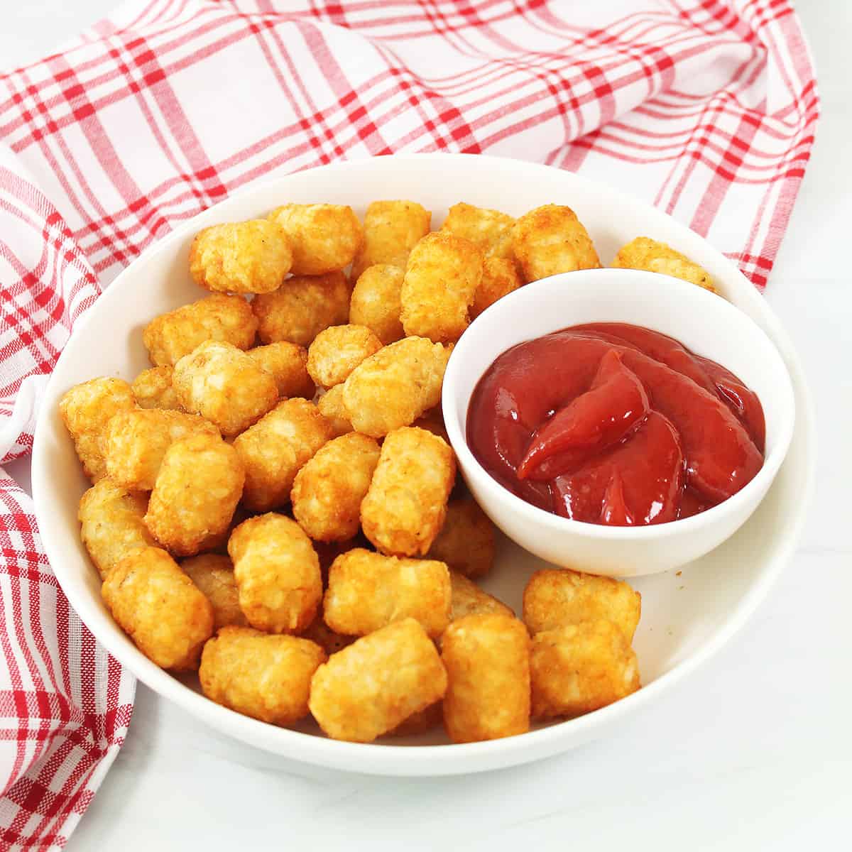 Air Fryer Tater Tots in bowl with ketchup.