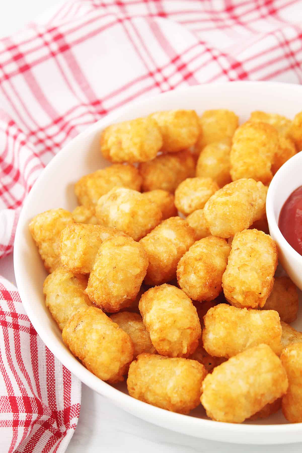 Closeup of crispy tater tots in bowl.