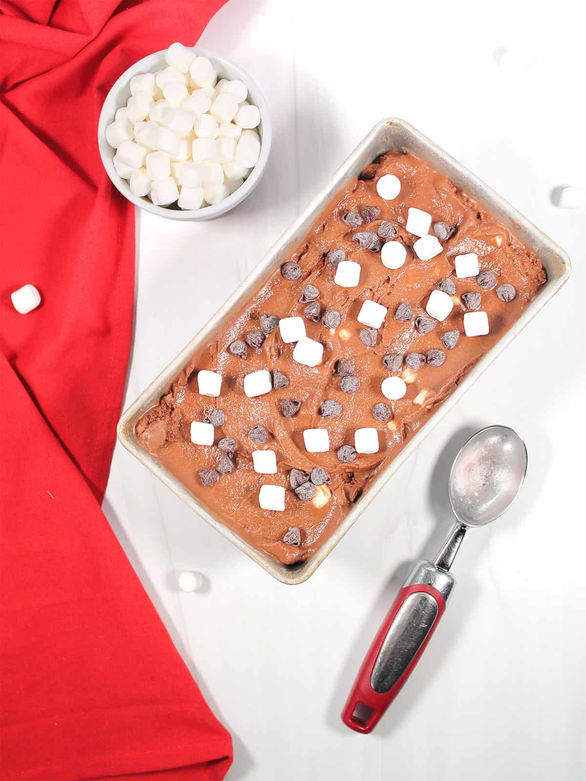 Ice cream in loaf pan with marshmallows and chocolate chips.