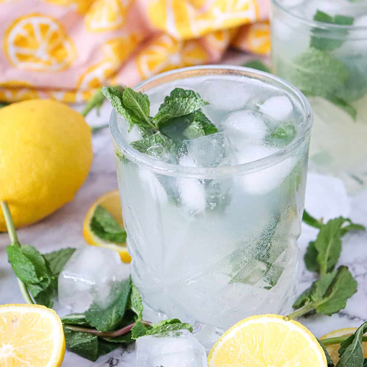 Single lemon mojito mocktail among lemons.