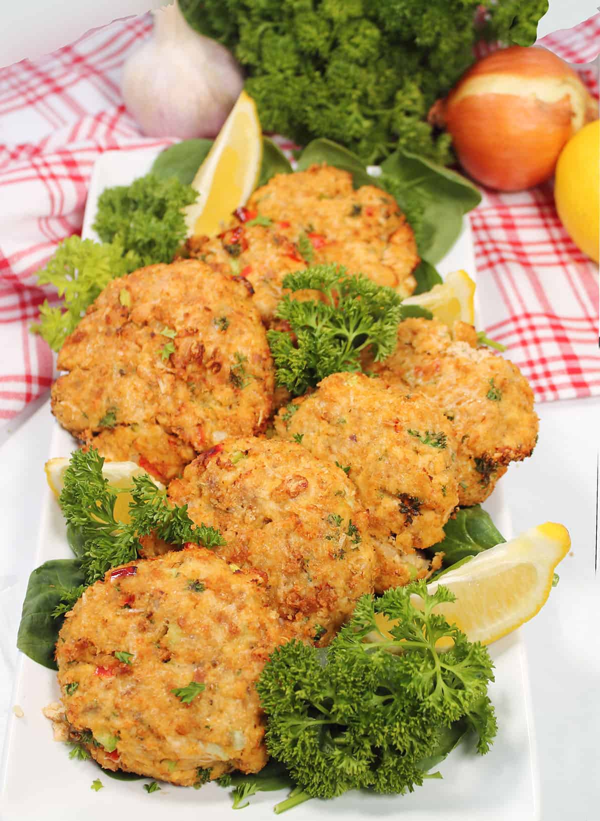 Air Fryer Salmon Patties on garnished platter with lemons.