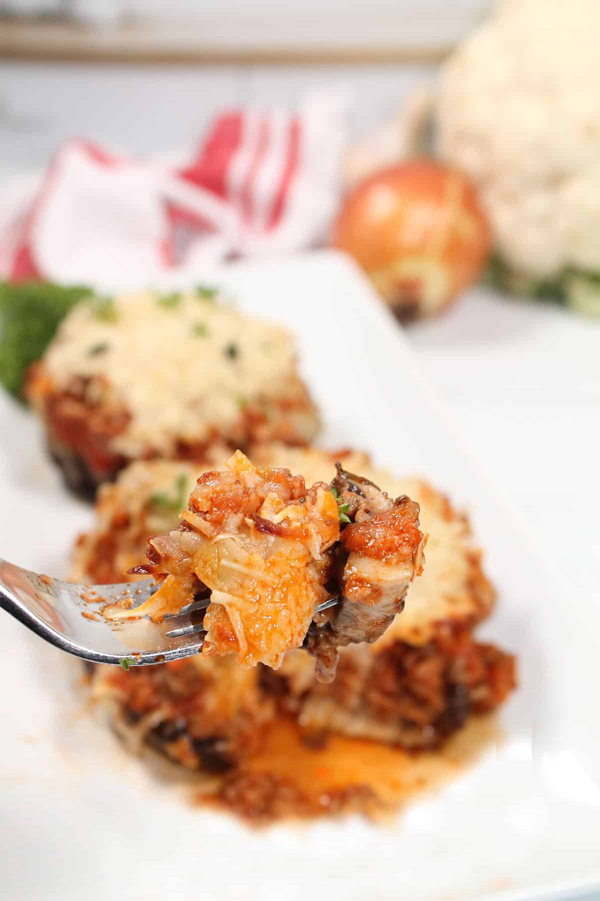 Bite of mushroom and ground beef filling on fork.