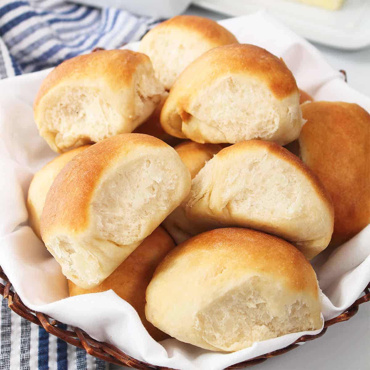 Closeup of air fryer dinner rolls in basket.