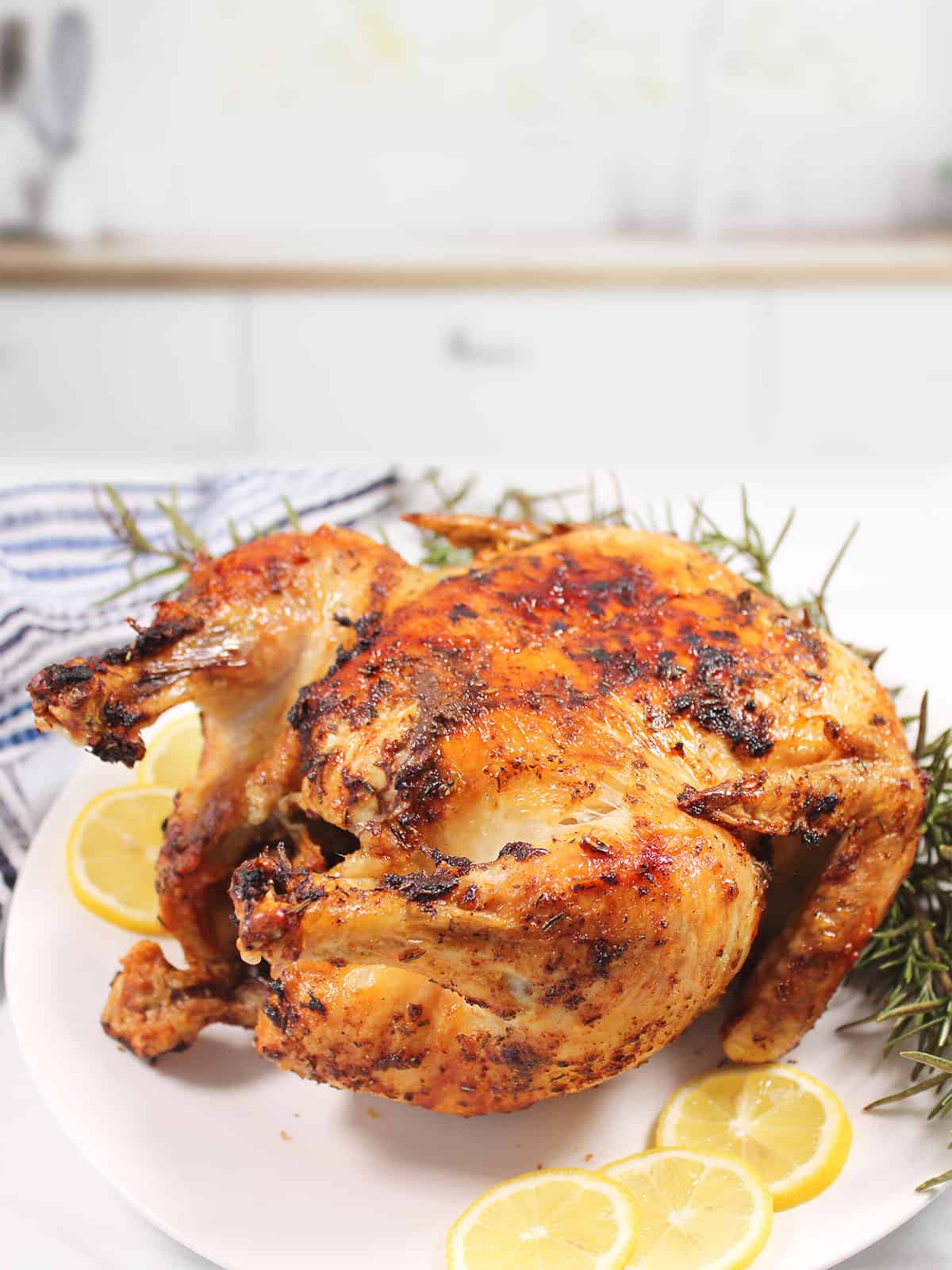 Air Fryer Frozen Whole Chicken cooked golden brown on platter.