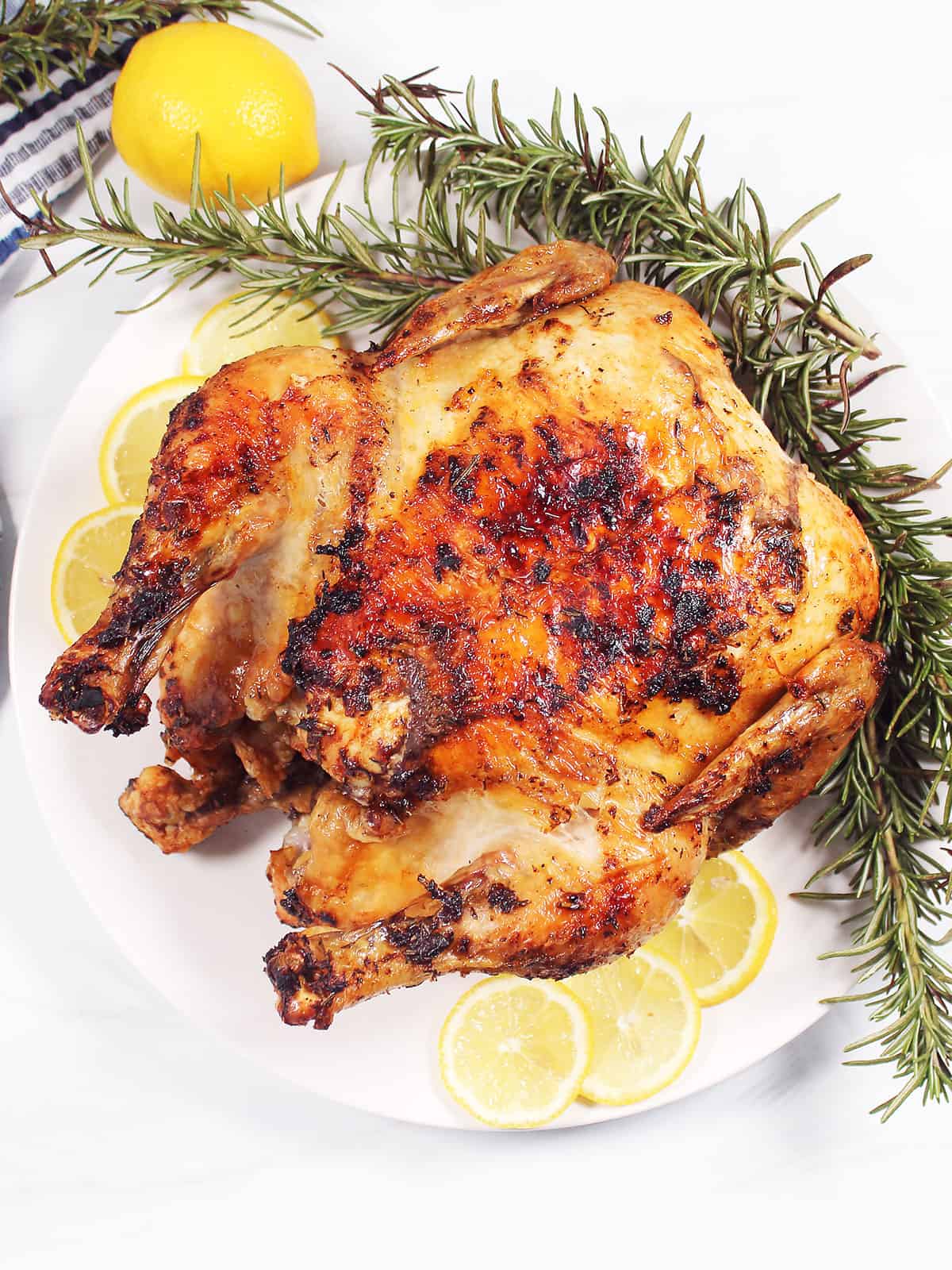 Golden brown crispy air fried whole chicken on platter.