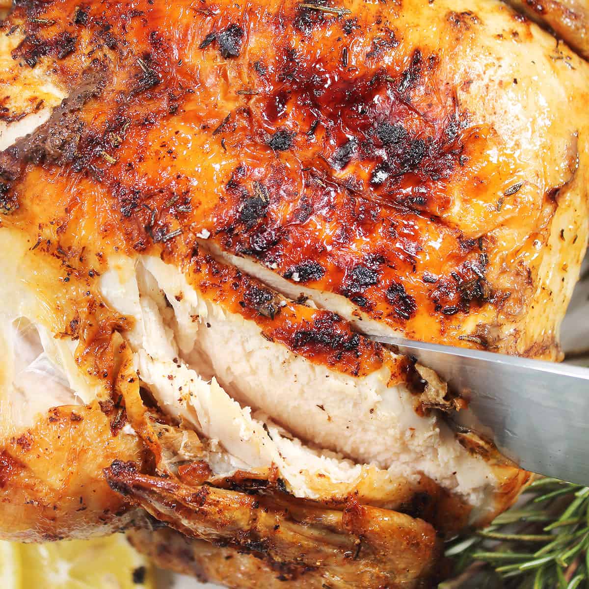 Slicing air fried whole chicken.