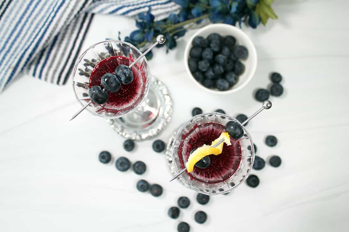 Overhead of blueberry bellini cocktails.