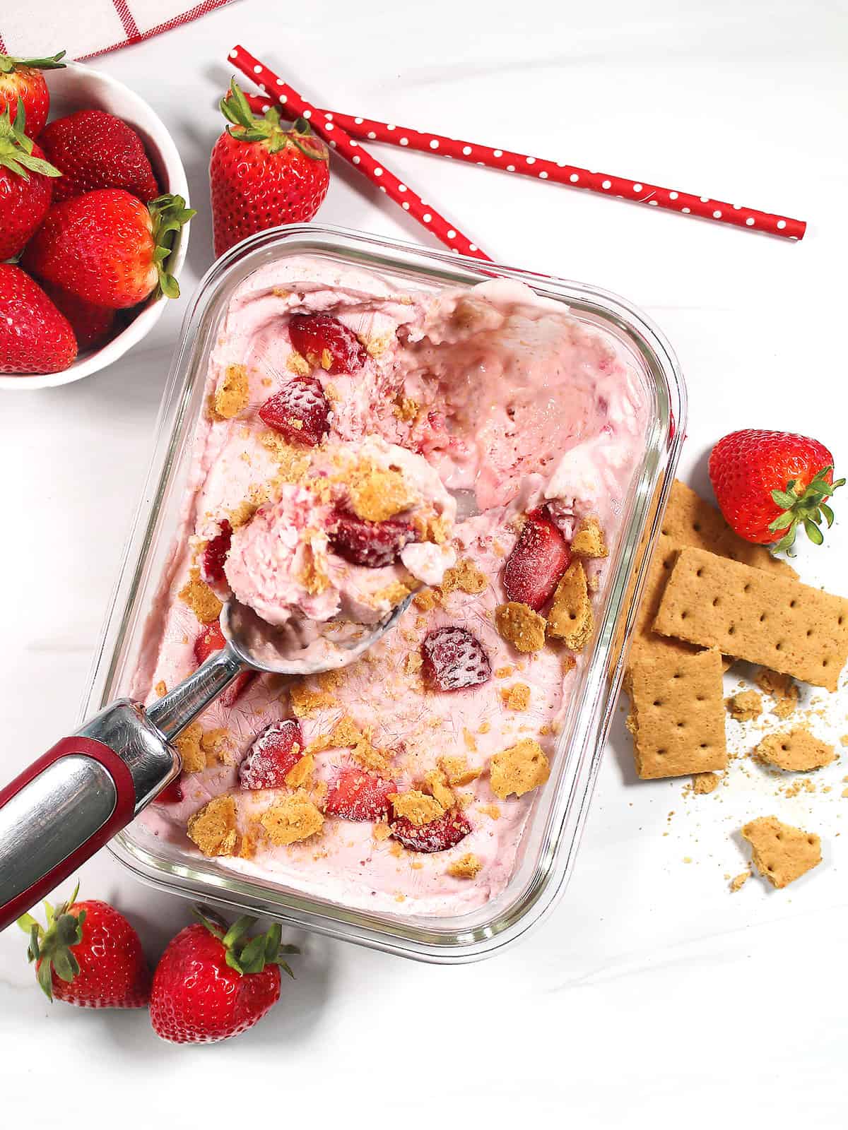 Scooping out frozen strawberry cottage cheese ice cream.