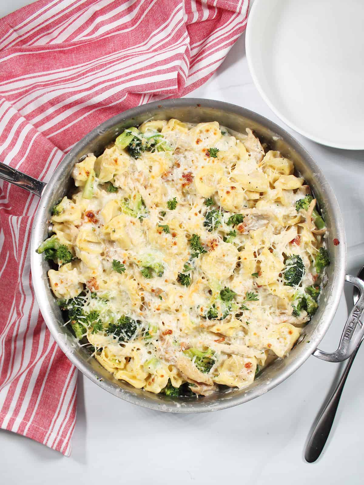 Overhead of One Pot Chicken Tortellini Alfredo with broccoli in pan.