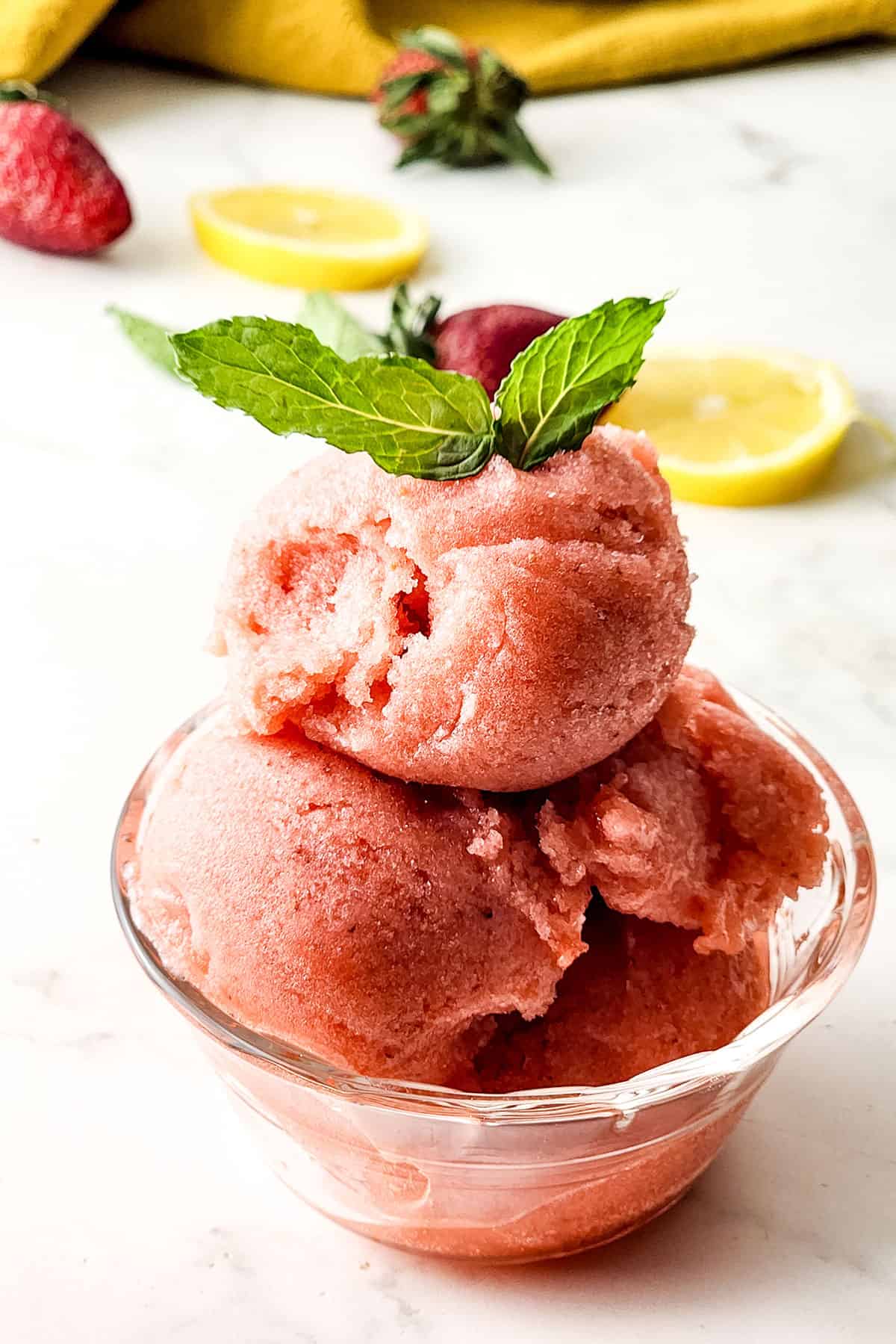 Strawberry Lemonade Sorbet in bowl with mint garnish.