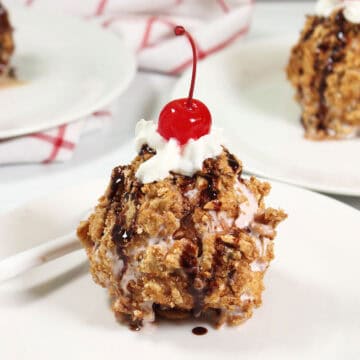 Closeup of fried ice cream with a cherry on top.