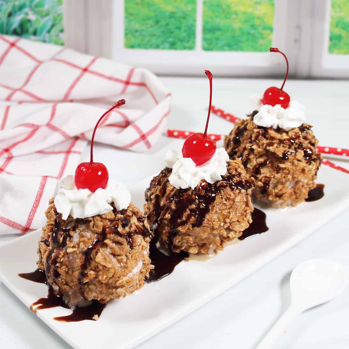 Three air fryer fried ice cream treats on a platter.